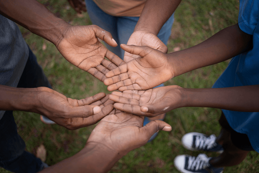People joining hands together in fellowship